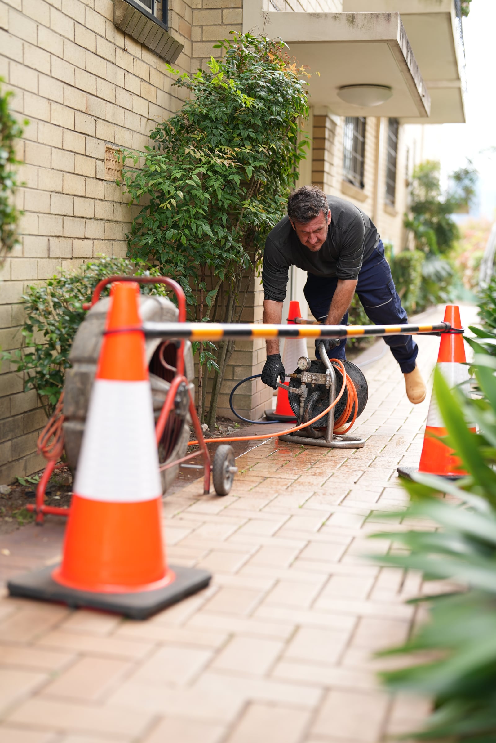 Drainr technician operating drain cleaning equipment at a Sydney home